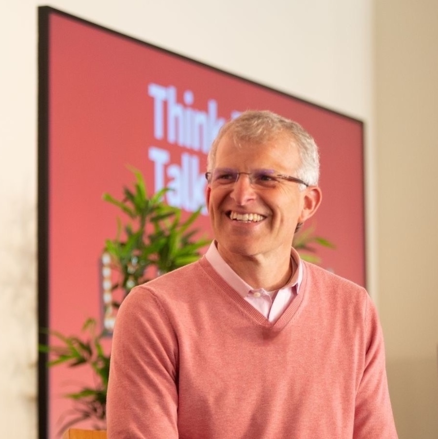 Matt Abrahams smiling in front of a Think Fast Talk Smart display